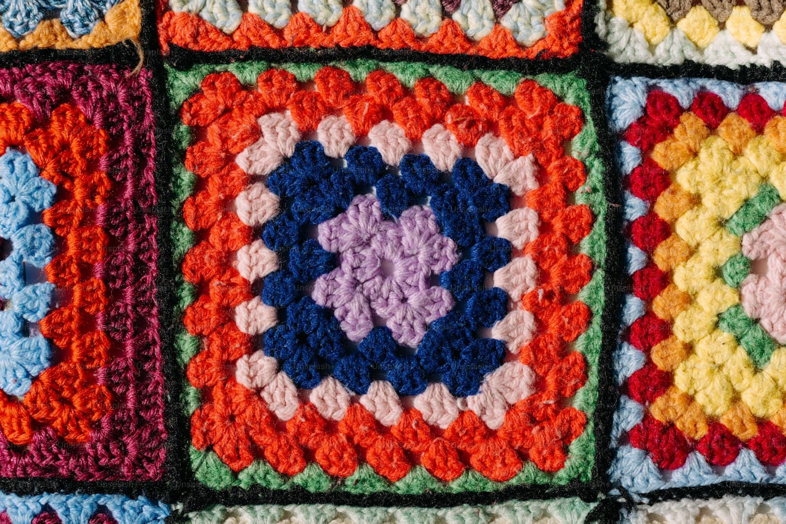 A blanket made of colorful crocheted granny squares