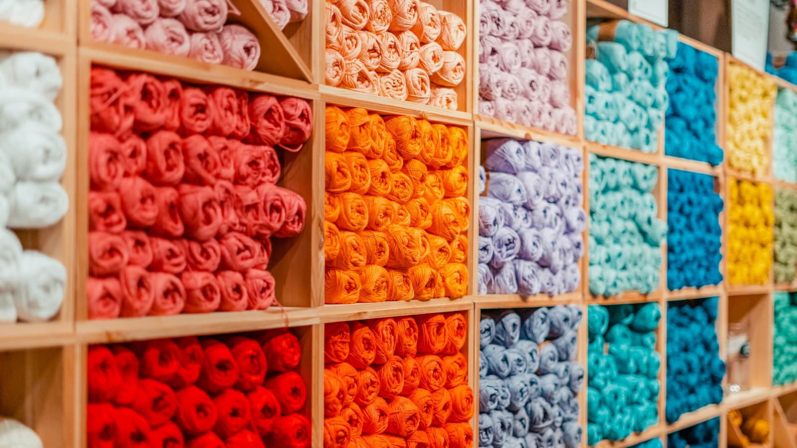 A store display of yarn skeins in many different colors