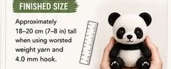 A finished sitting crocheted panda held in one hand next to a ruler, showing its finished height of about 18-20cm