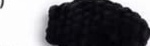Small lightly stuffed black chenille flipper, an elongated oval shape with a tapered tip