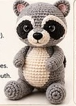 Fully assembled crocheted raccoon sitting upright, showing the belly stripe, ears, striped tail, and finished face all in place